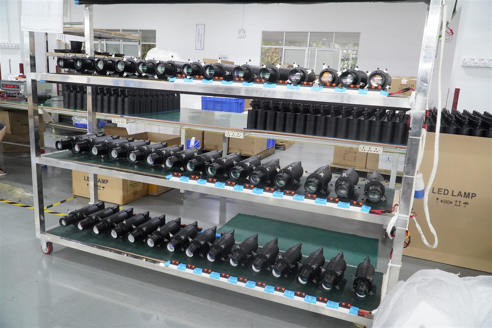 Finished track light fixtures on final inspection racks at ENCORE factory