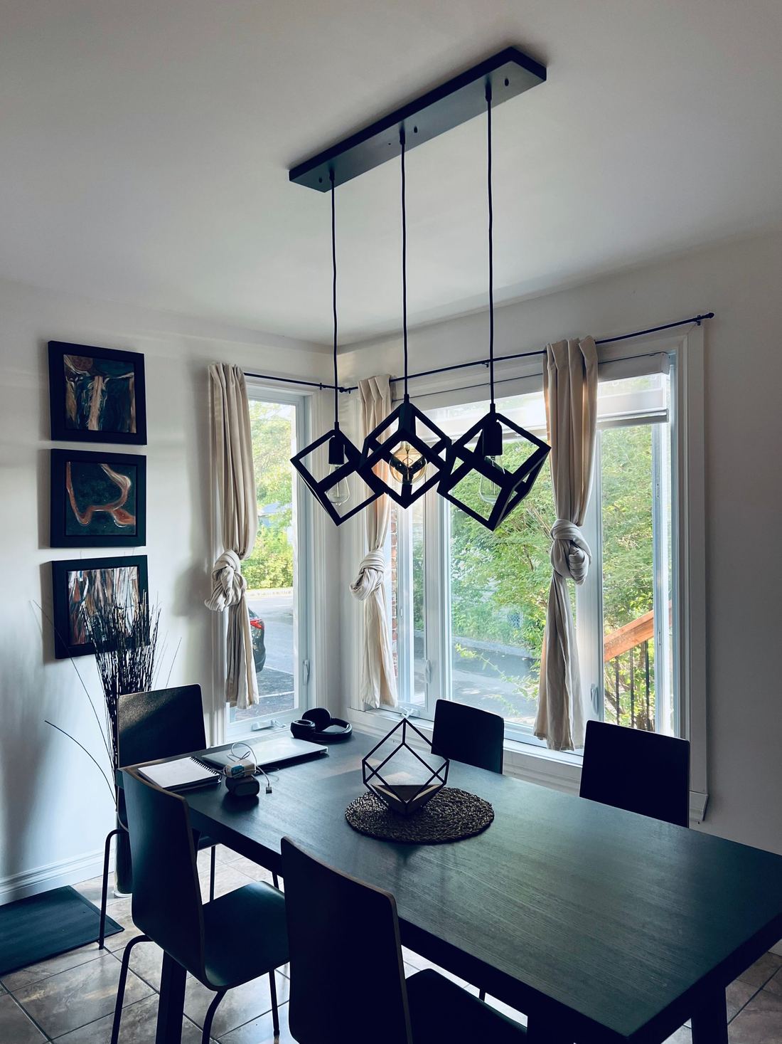 Geometric pendant lighting in a chic dining room over the table