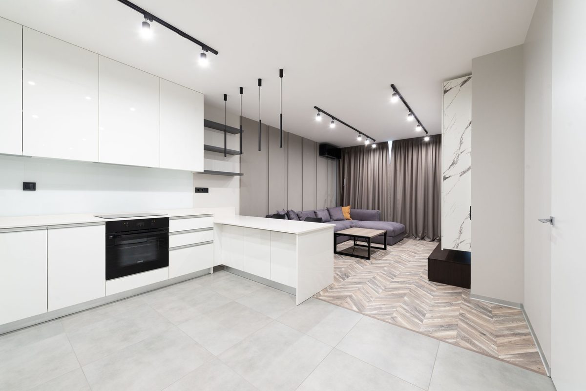 Open plan kitchen and living room with LED track lighting for flexible task and accent light