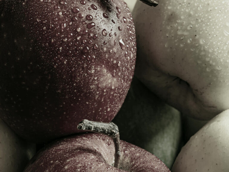 Close up of a wet deep red apple under high R9 LED lighting, the hidden color rendering number that makes red look red