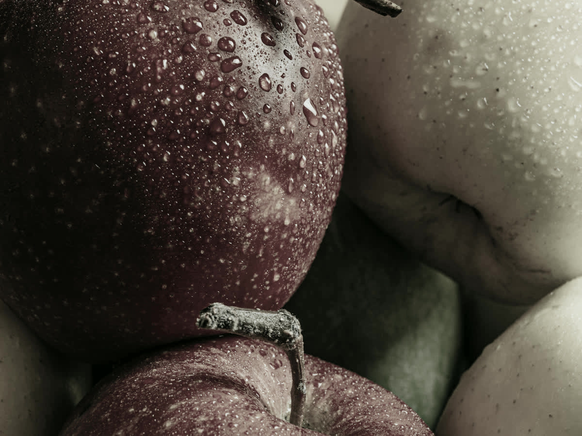 Close up of a wet deep red apple under high R9 LED lighting, the hidden color rendering number that makes red look red
