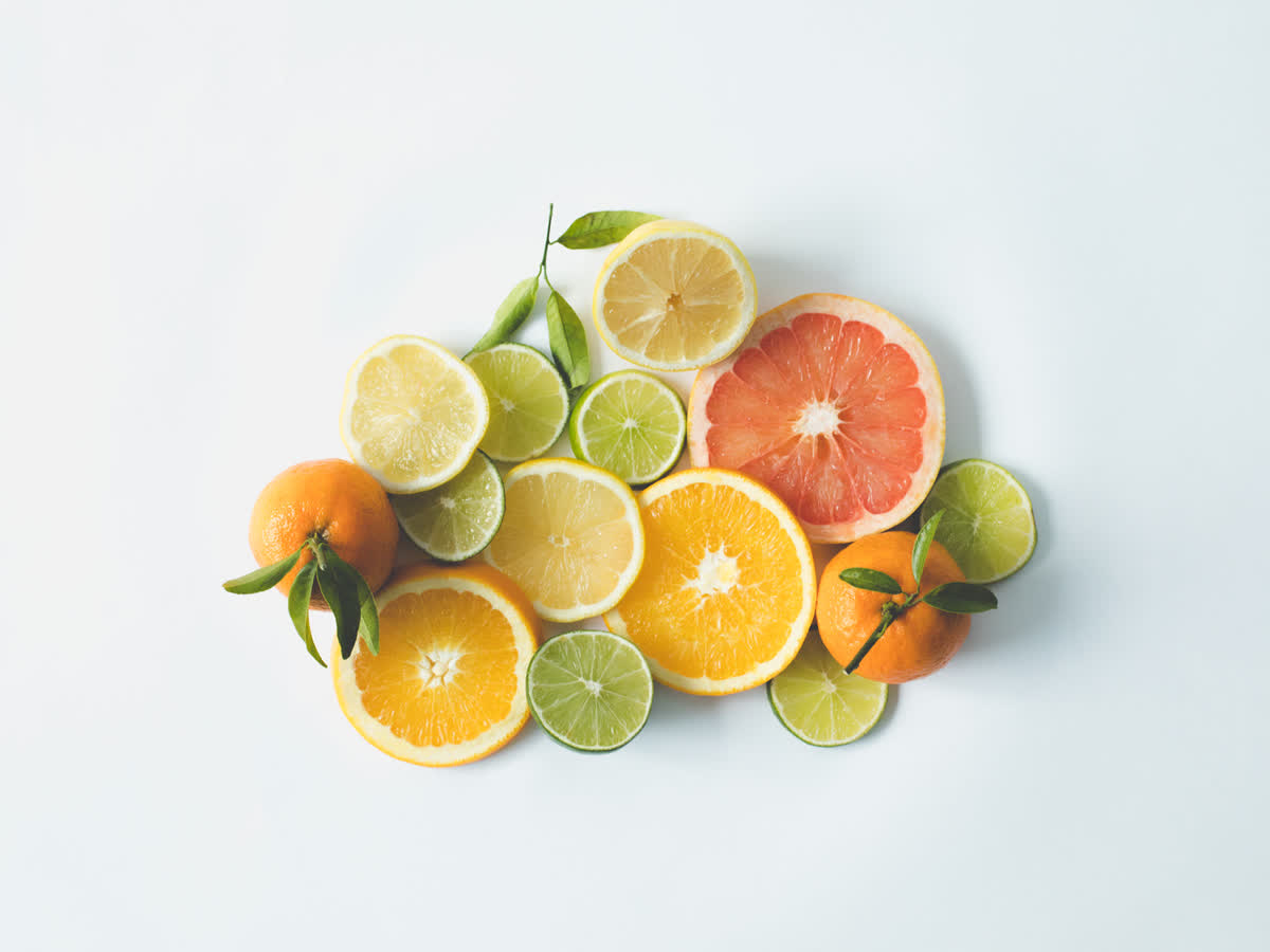 Citrus fruit cut open on a white studio surface showing the red-orange saturation that R9 color rendering must reproduce accurately