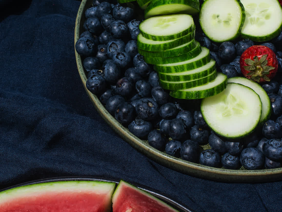 Watermelon, strawberries and cucumbers on linen cloth showing how high R9 color rendering keeps red fruit saturated instead of dull