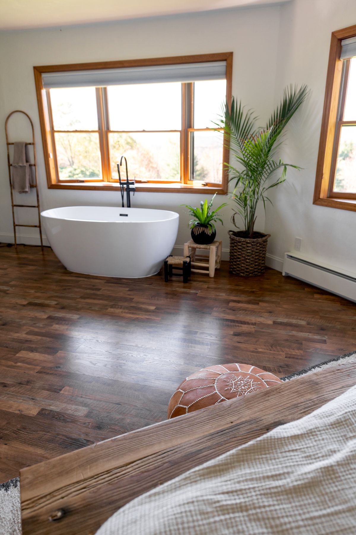Cozy Scandinavian bathroom with freestanding bathtub lit by warm low-glare LED lighting