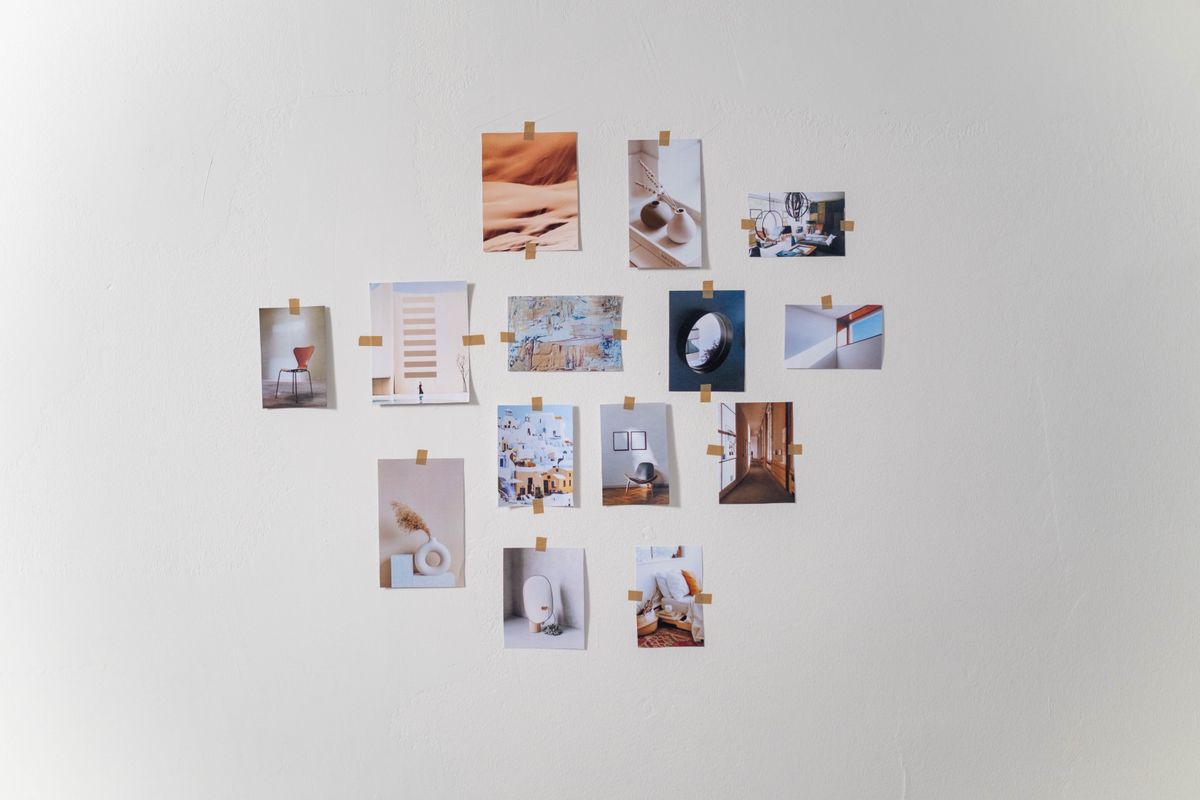 Minimalist gallery wall of framed photos in a cozy Nordic home with warm art lighting