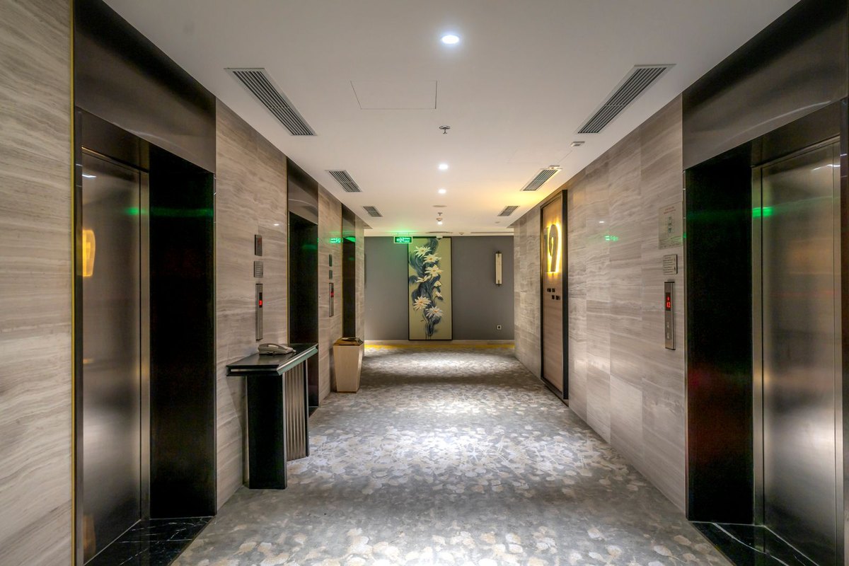 Long hallway where every ceiling light sits inside the sight line, the case where glare-free lighting depends on shielding rather than geometry