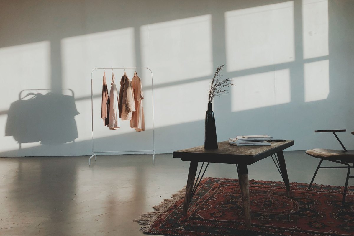 Modern interior with daylight from a full height window falling onto a bare floor, an example of a room where glare-free lighting is balanced against daylight