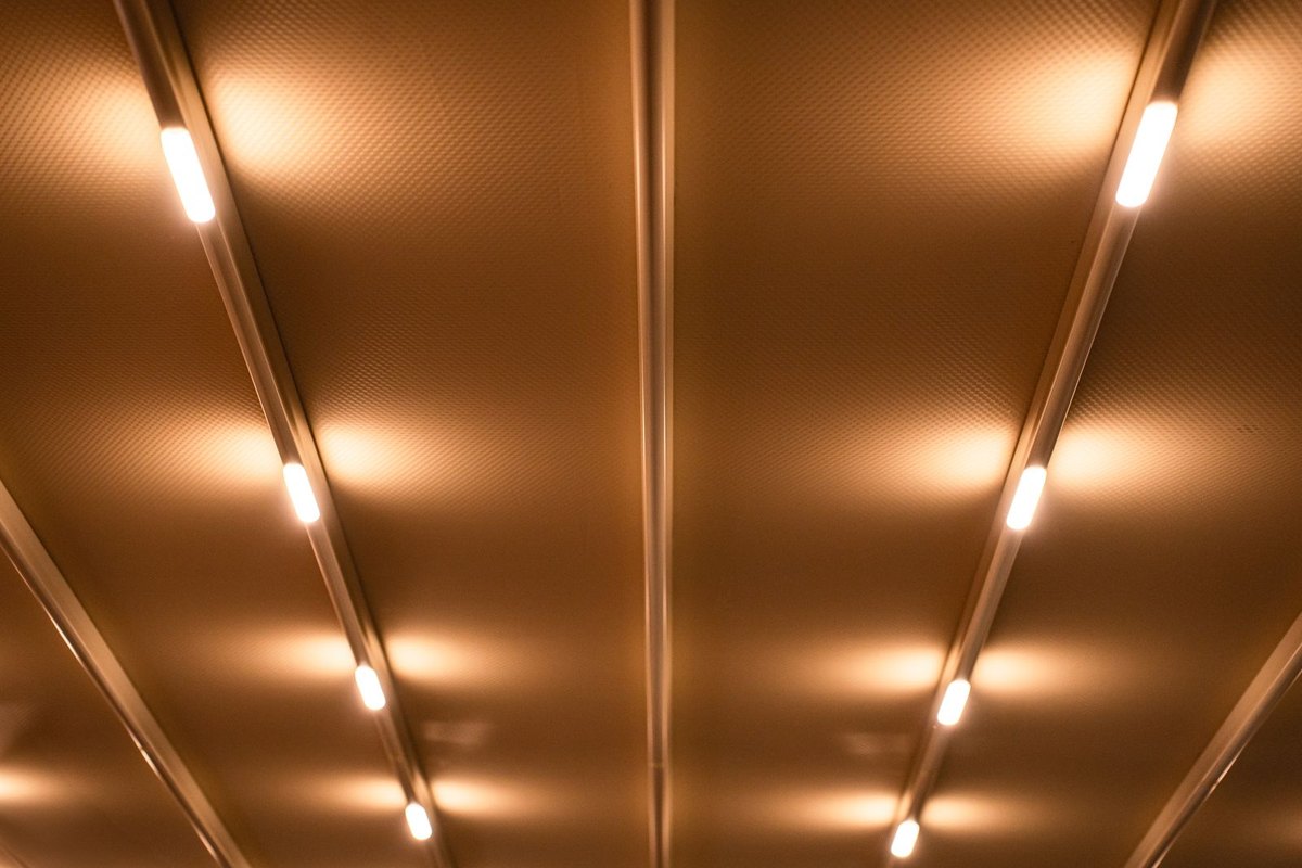 Linear luminous ceiling wash in warm tones, an example of continuous low luminance lighting used to raise background luminance rather than create a bright source