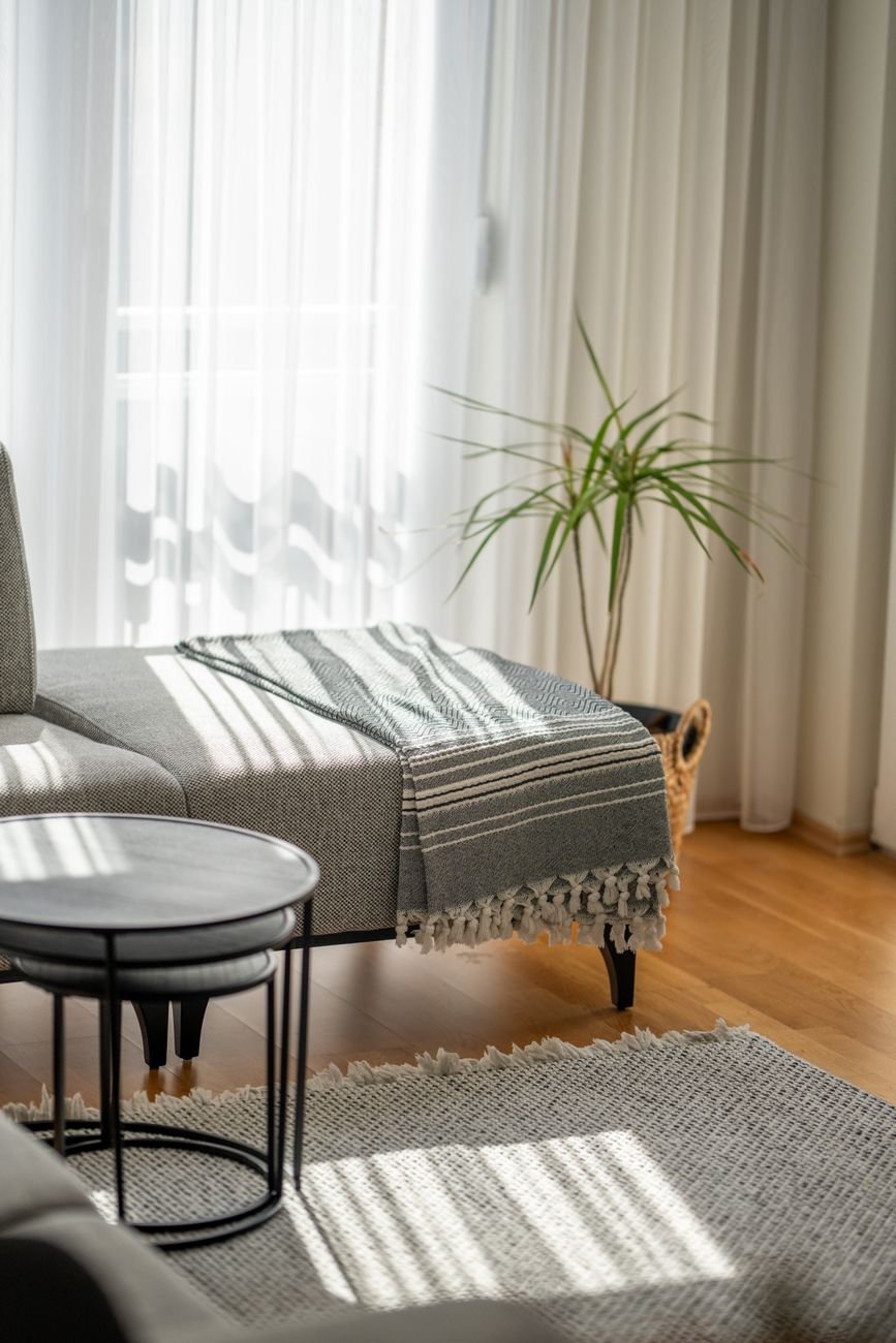Sunlit Scandinavian living room with minimalist furniture and warm natural light in a Nordic home