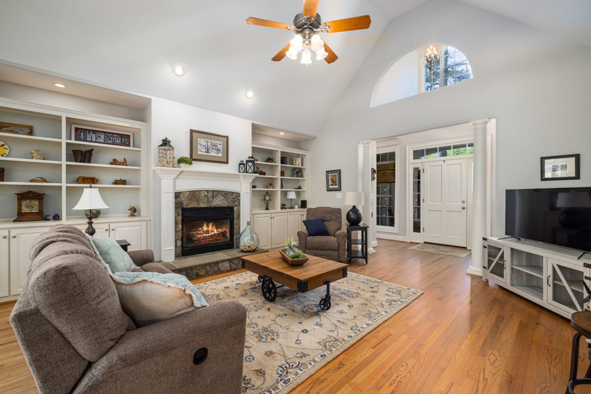 Vaulted living room with a tall ceiling where track light spacing has to be calculated from beam angle and mounting height