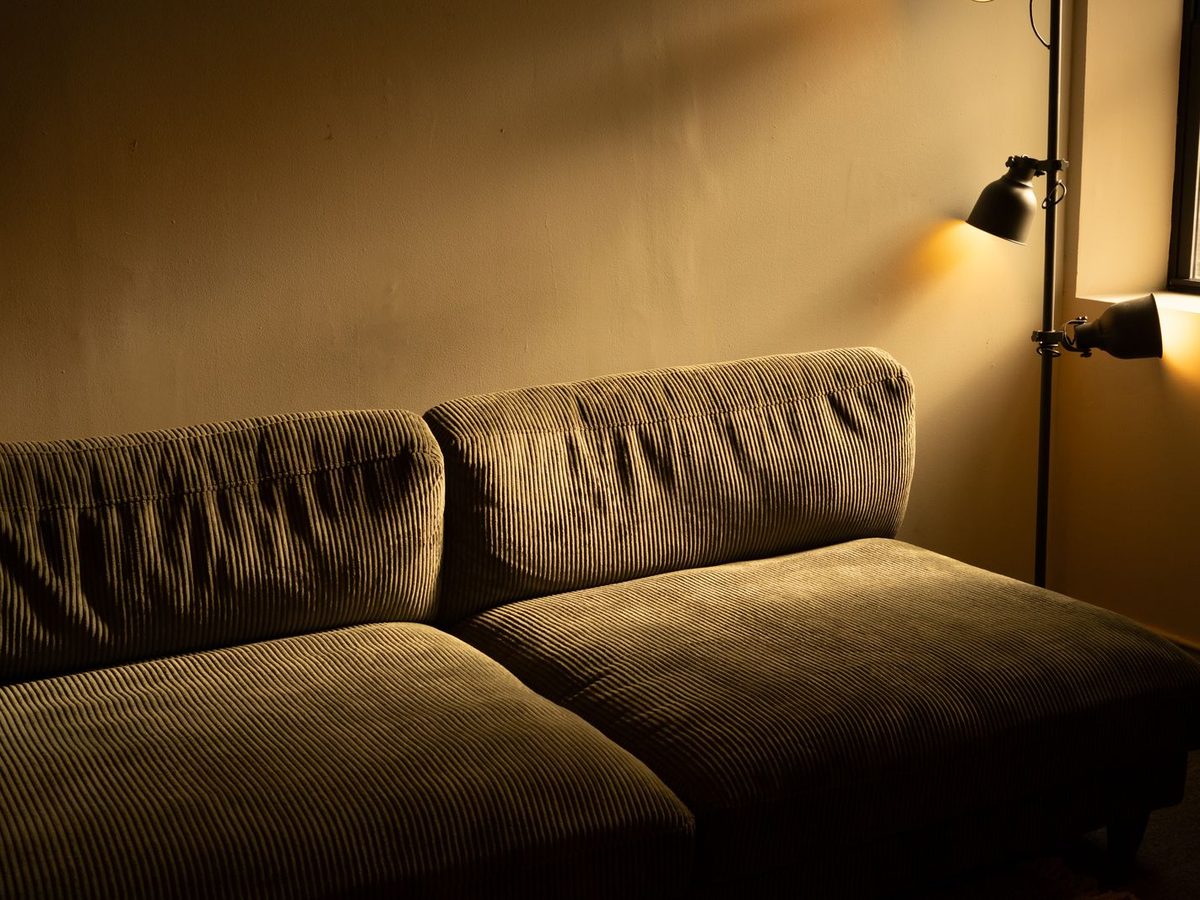 CRI vs TM-30 explained in a warm boho living room with saturated rust, mustard and olive tones under warm LED lighting